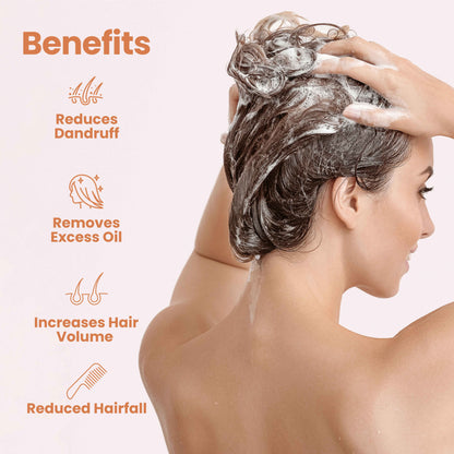 Woman washing her hair with bio valley cedarwood shampoo